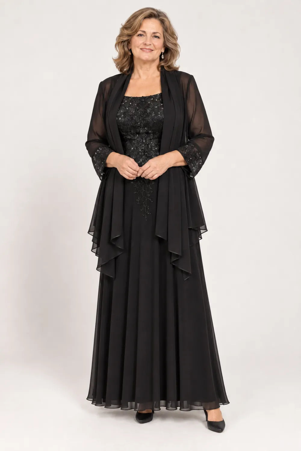 Black dress with floral bodice and matching decorated cuffs, front view.