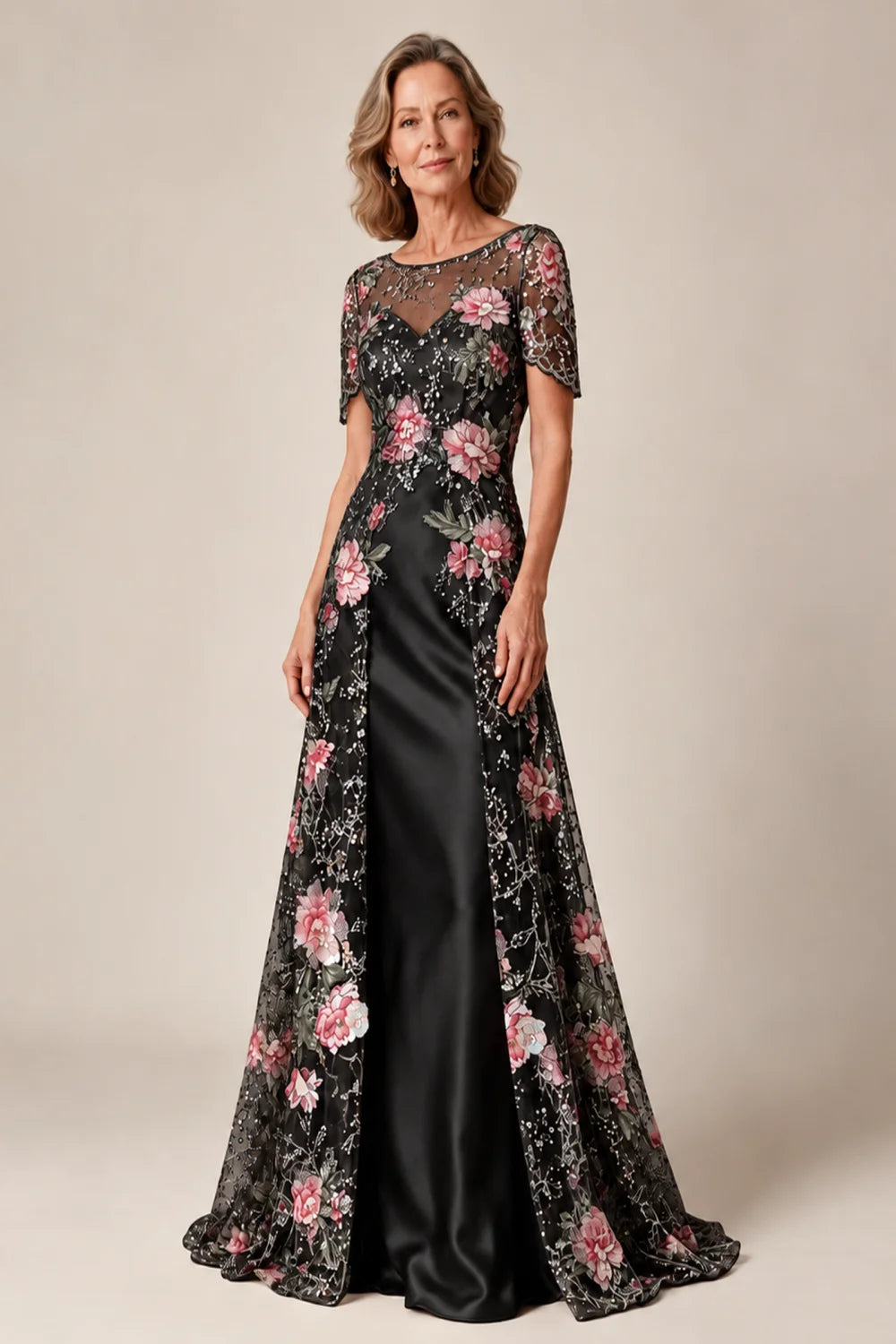 Front view of a black dress with a floral overlay and plain inner skirt.