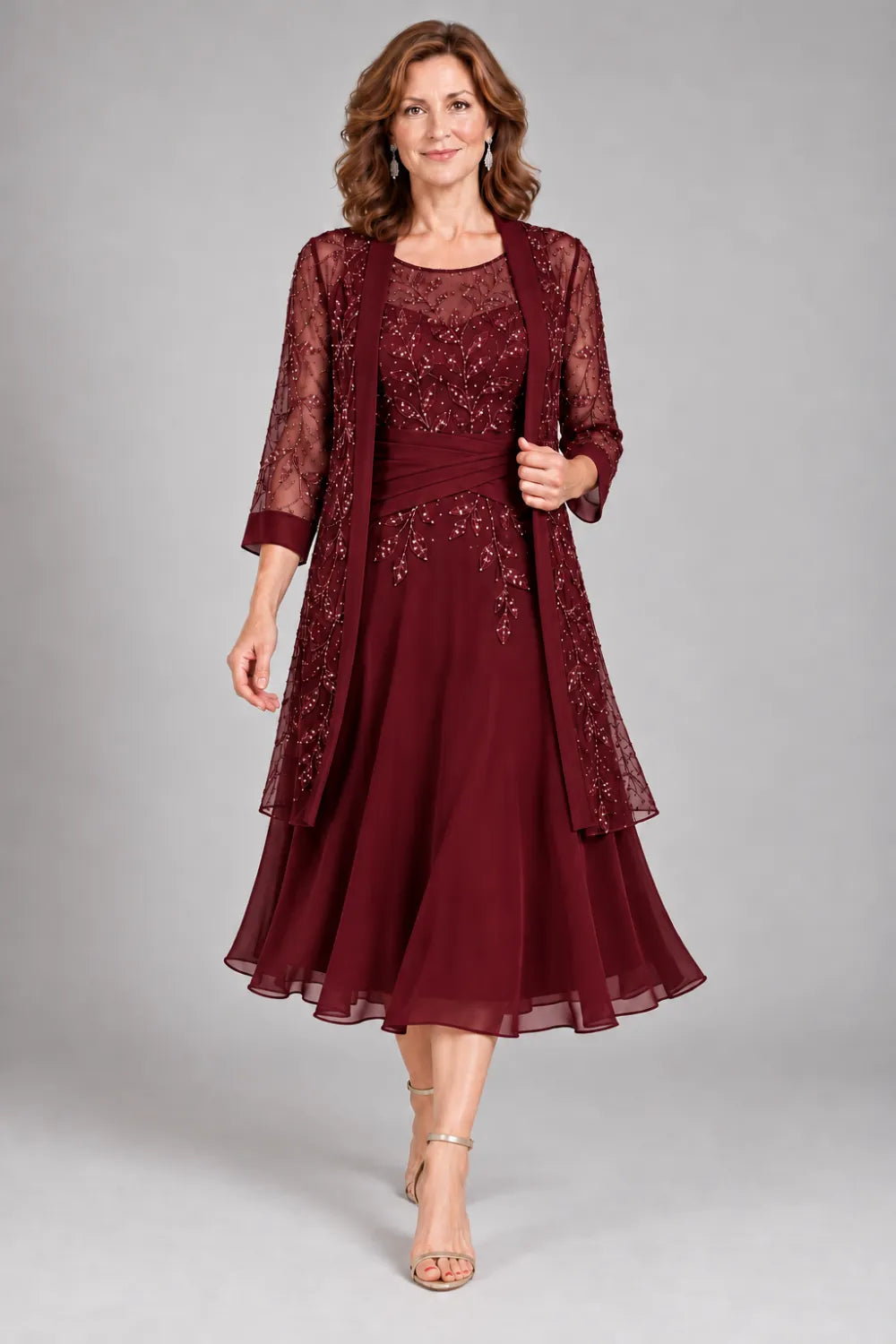 Burgundy dress with floral lace extending below the waist, front view.