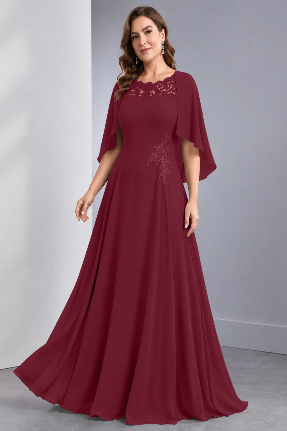 Front view of a burgundy dress with draped sleeve panels and a lace neckline.