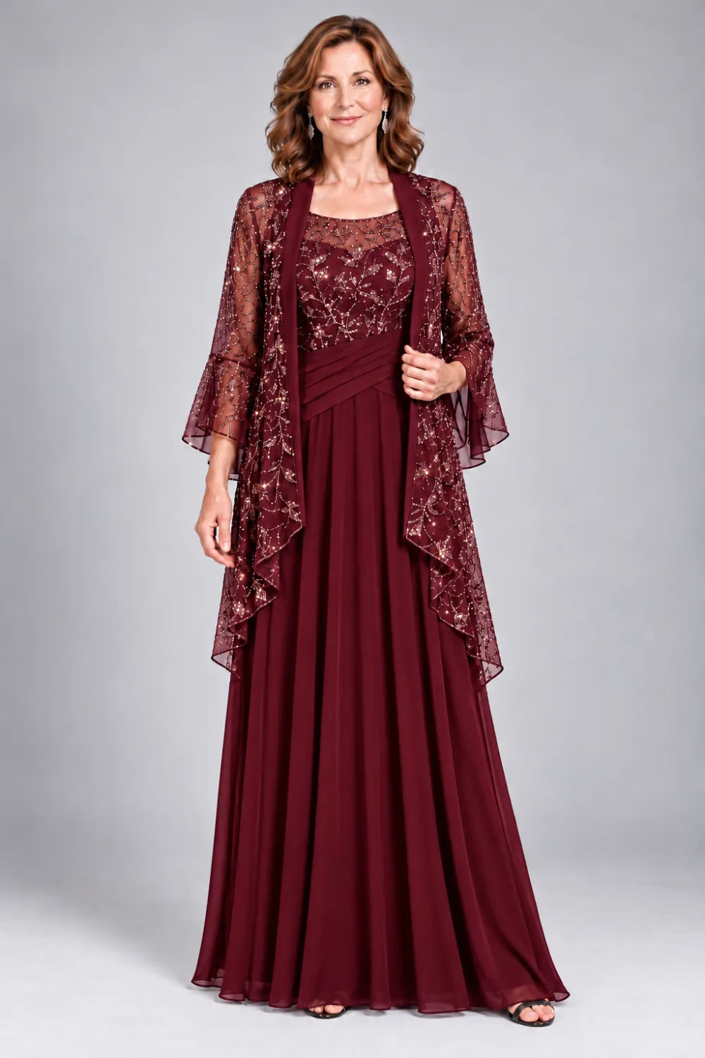 Burgundy dress with floral decorated bodice and diagonal gathered waist, front view.
