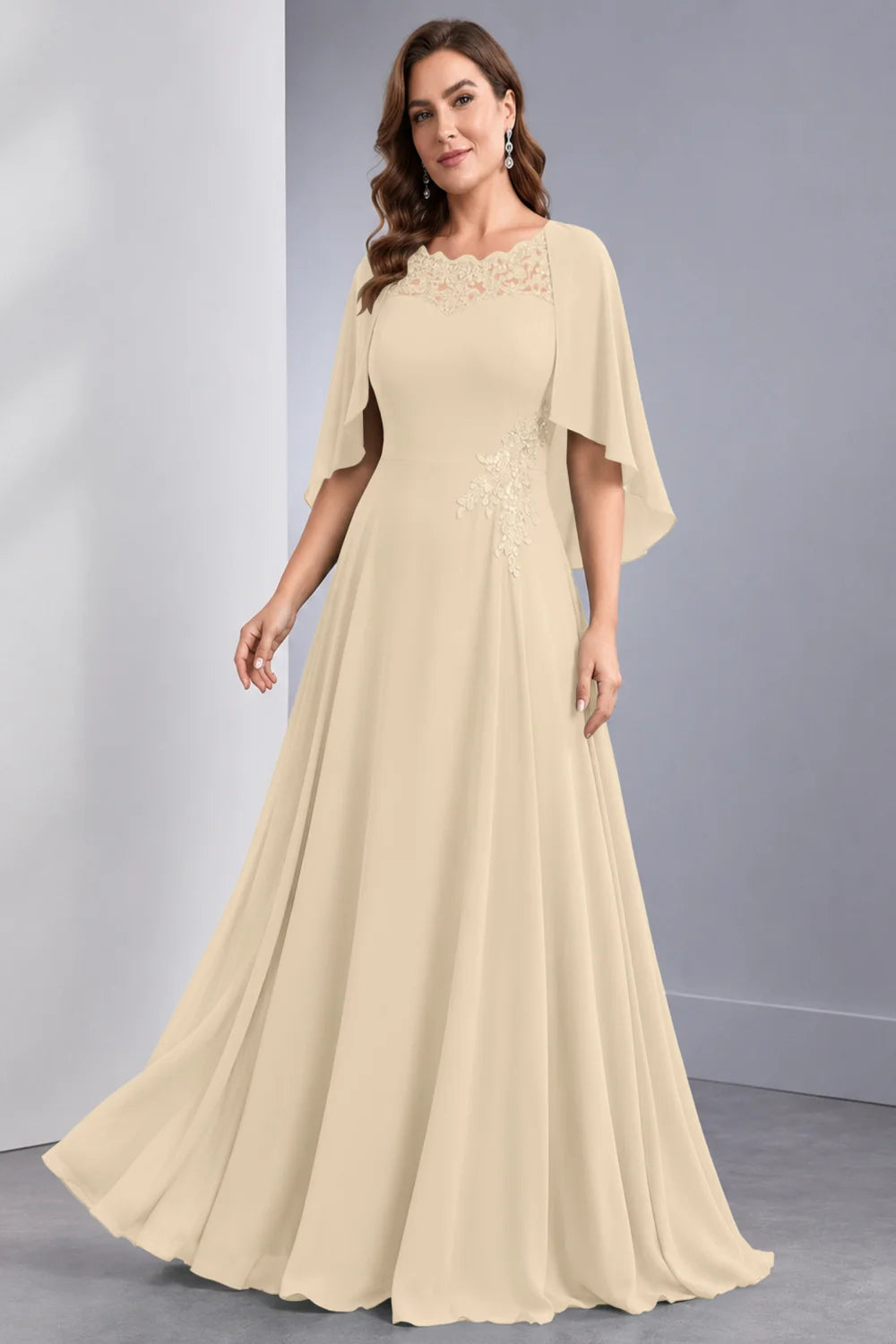 Front view of a champagne dress with draped sleeve panels and a lace neckline.