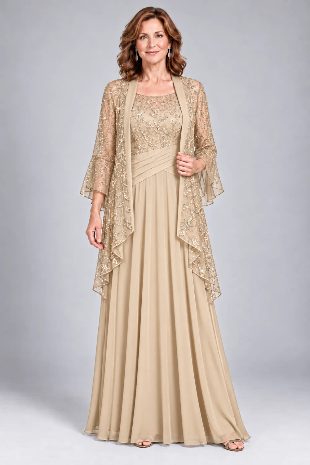 Champagne dress with floral decorated bodice and diagonal gathered waist, front view.