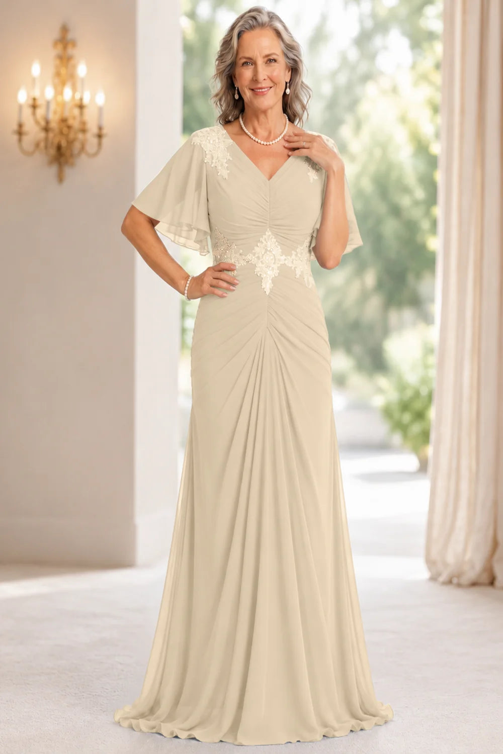 Front view of a champagne dress with flutter sleeves and a ruched front.