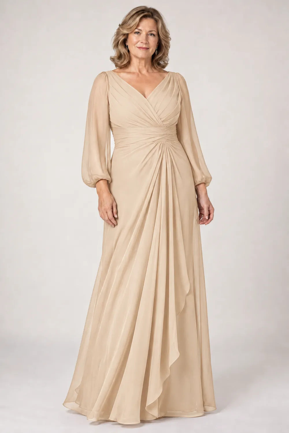 Champagne dress with crossover bodice, gathered waist and cascading side panel, front view.