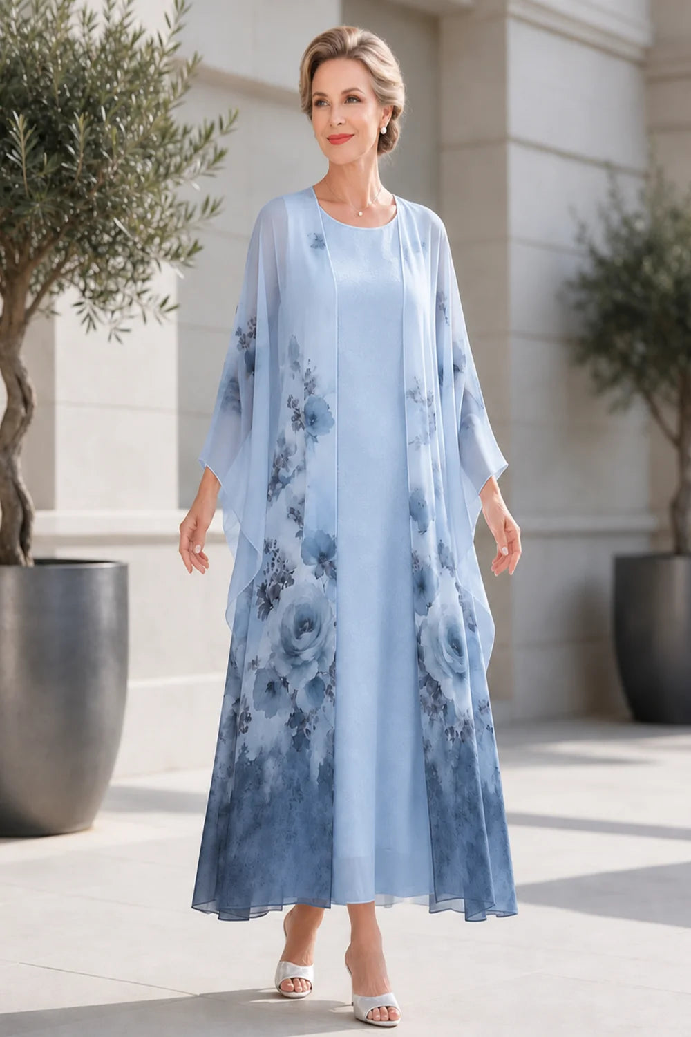 Front view of a dusty blue dress with a long floral outer layer.
