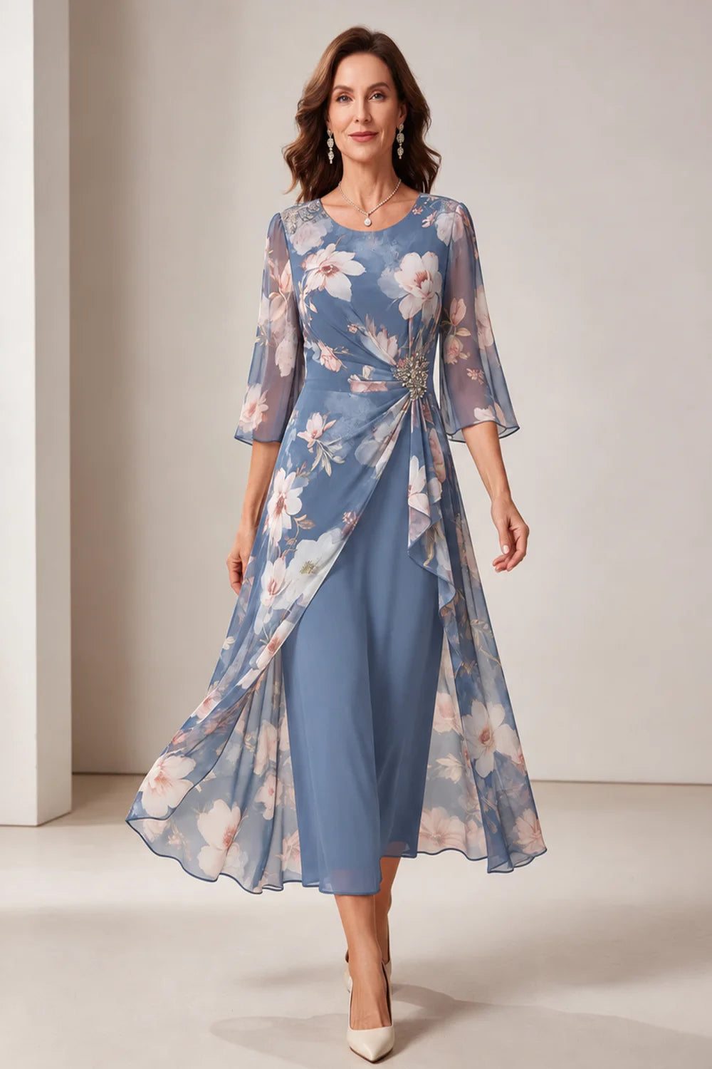 Front view of a dusty blue dress with a floral overlay and flared sleeves.