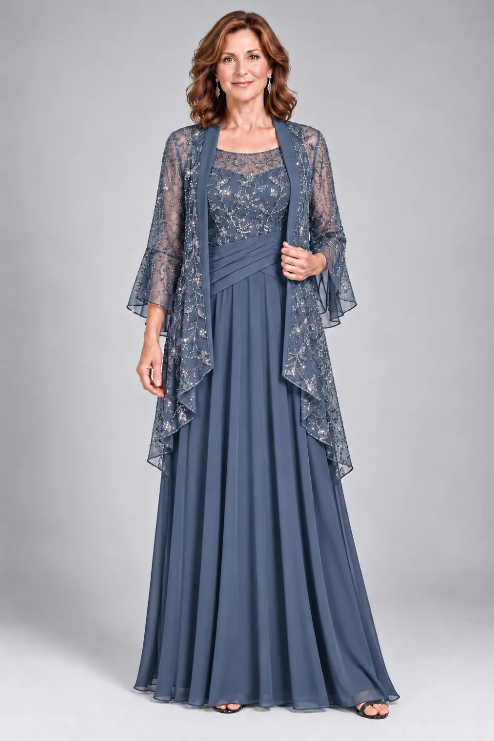 Dusty Blue dress with floral decorated bodice and diagonal gathered waist, front view.