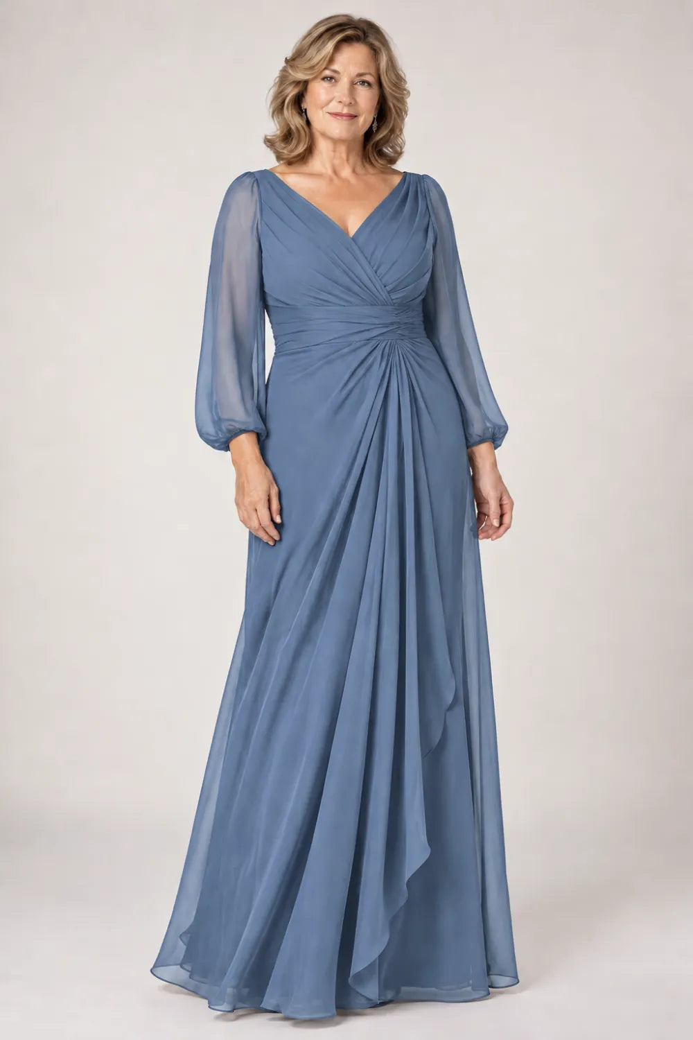 Dusty Blue dress with crossover bodice, gathered waist and cascading side panel, front view.