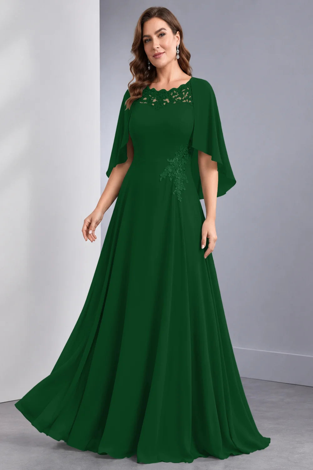 Front view of a emerald green dress with draped sleeve panels and a lace neckline.