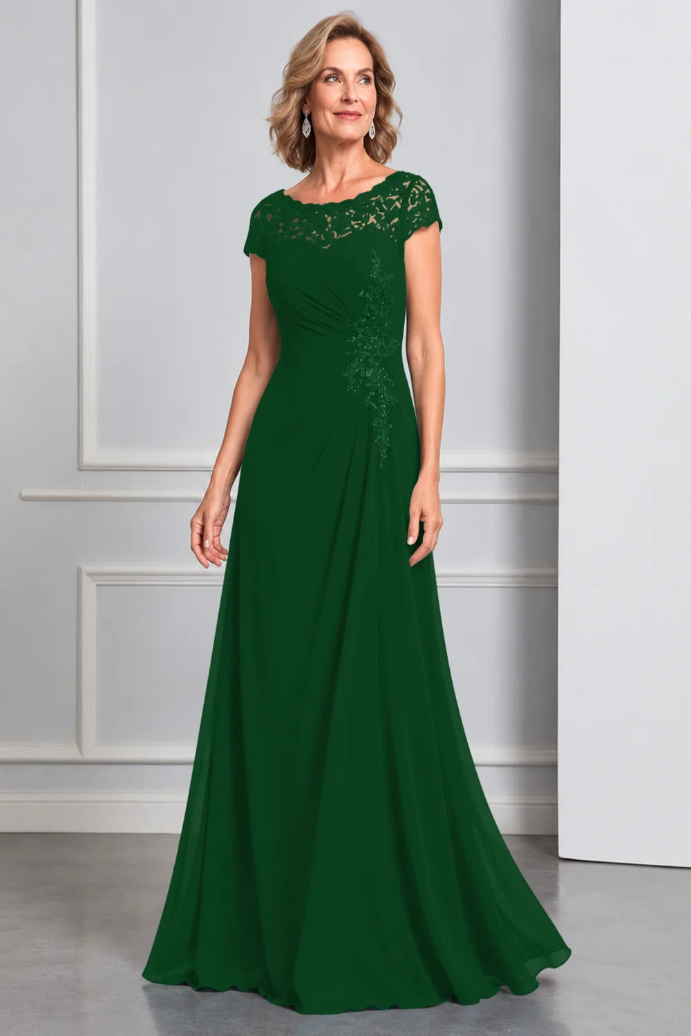 Front view of a emerald green dress with lace cap sleeves and side waist decoration.