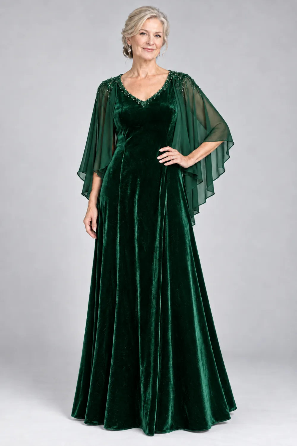 Emerald Green dress with beaded v-neck and layered cascading cape, front view.