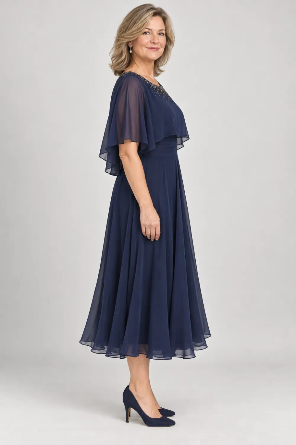 Navy Blue dress with narrow beaded neckline and defined waist, side view.