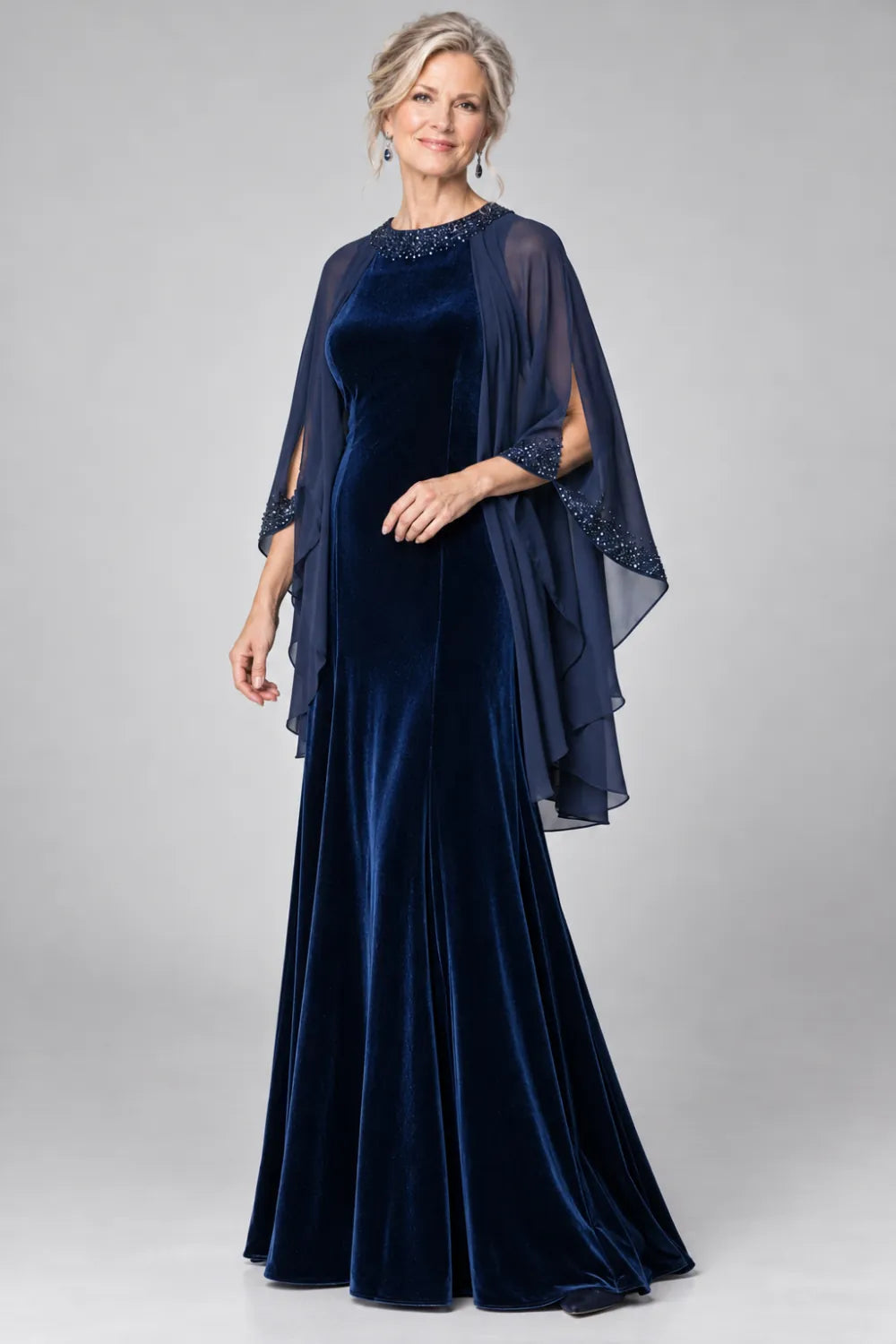 Navy Blue dress with beaded round neckline and cascading sheer cape, posed front view.