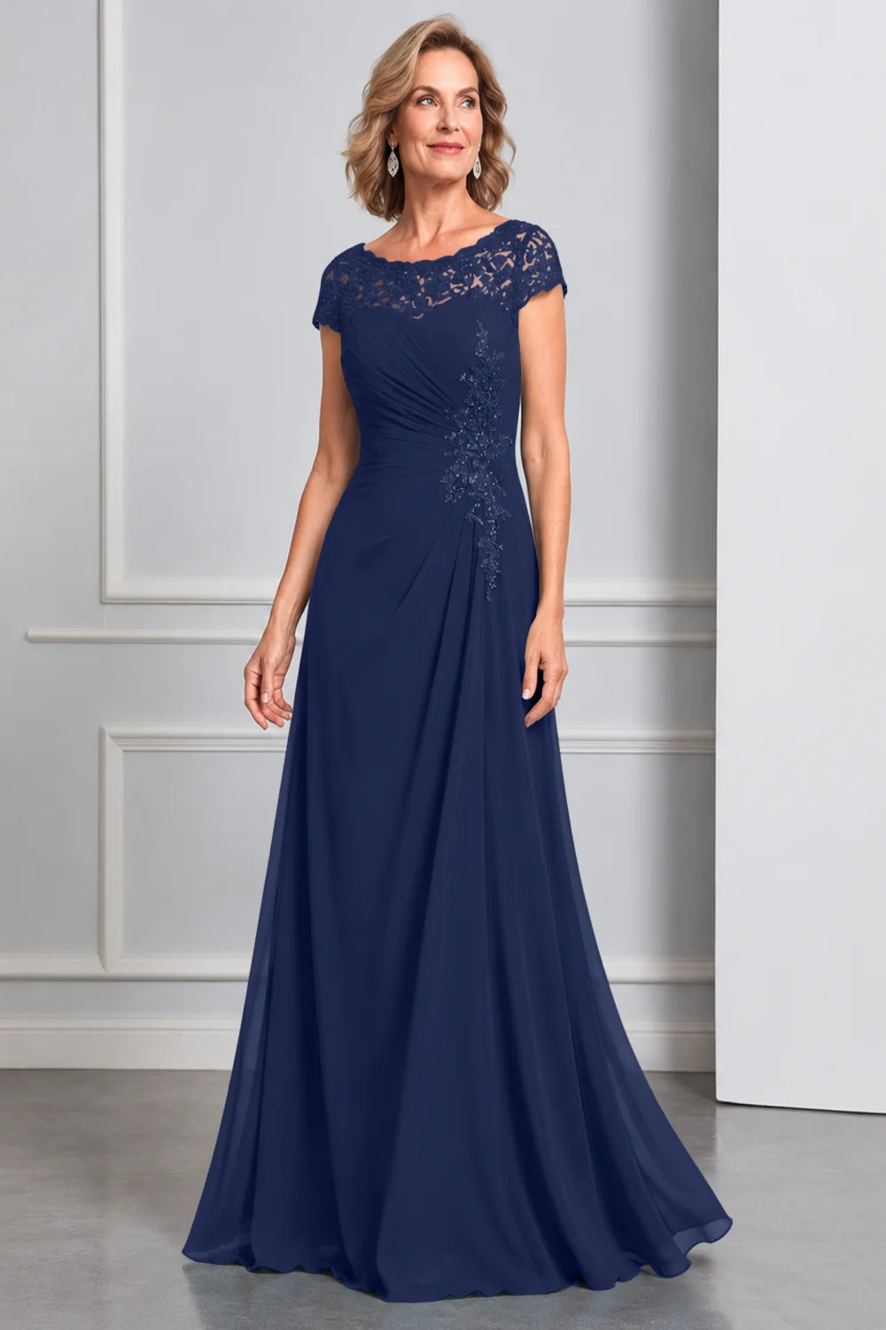 Front view of a navy blue dress with lace cap sleeves and side waist decoration.