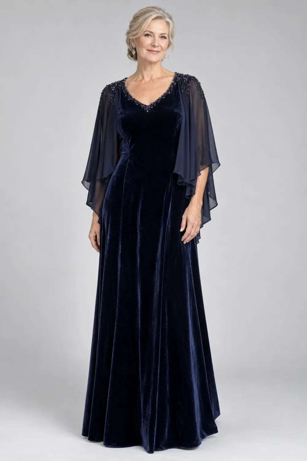 Navy Blue dress with beaded v-neck and layered cascading cape, front view.