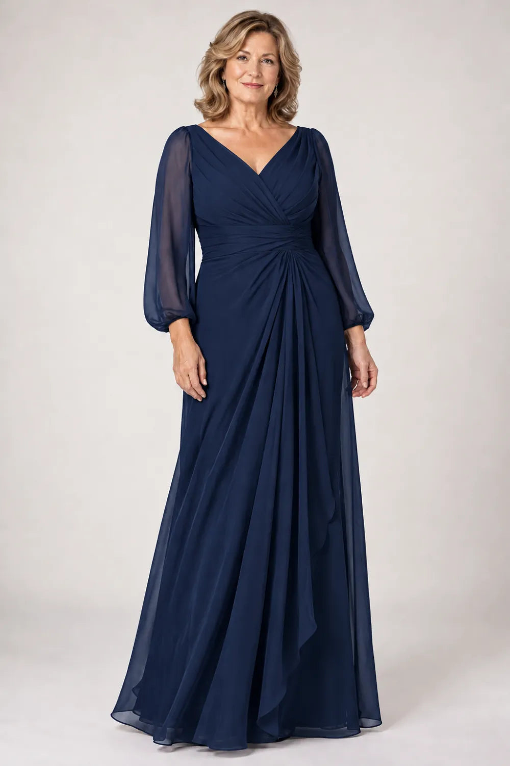 Navy Blue dress with crossover bodice, gathered waist and cascading side panel, front view.