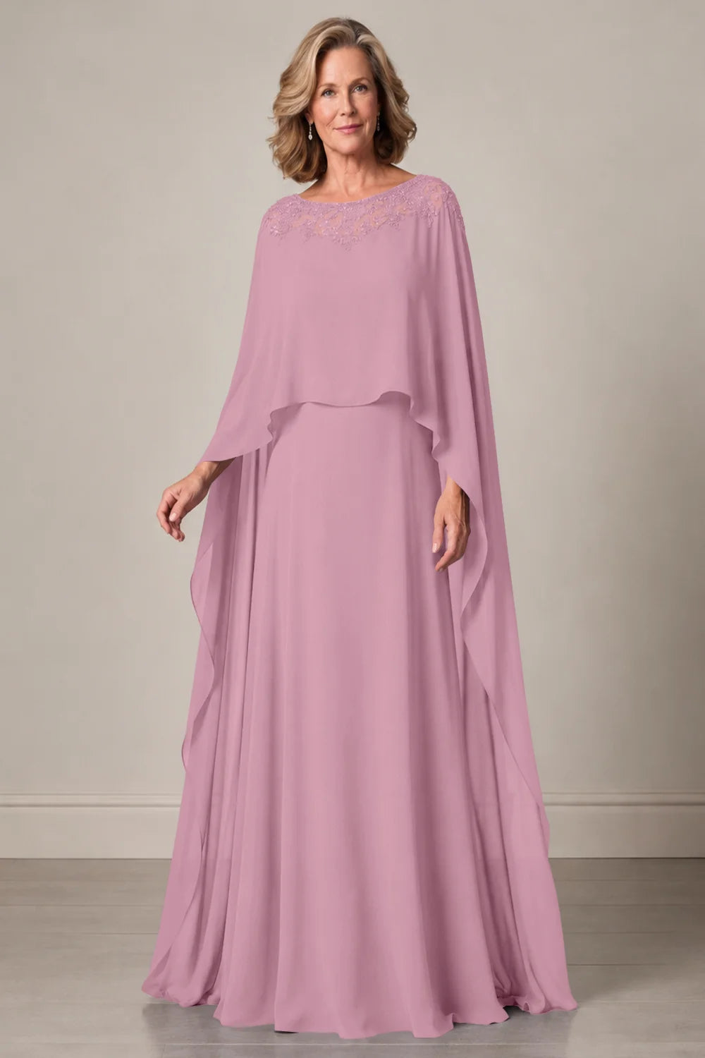 Front view of a pink dress with a decorated neckline and long cape panels.