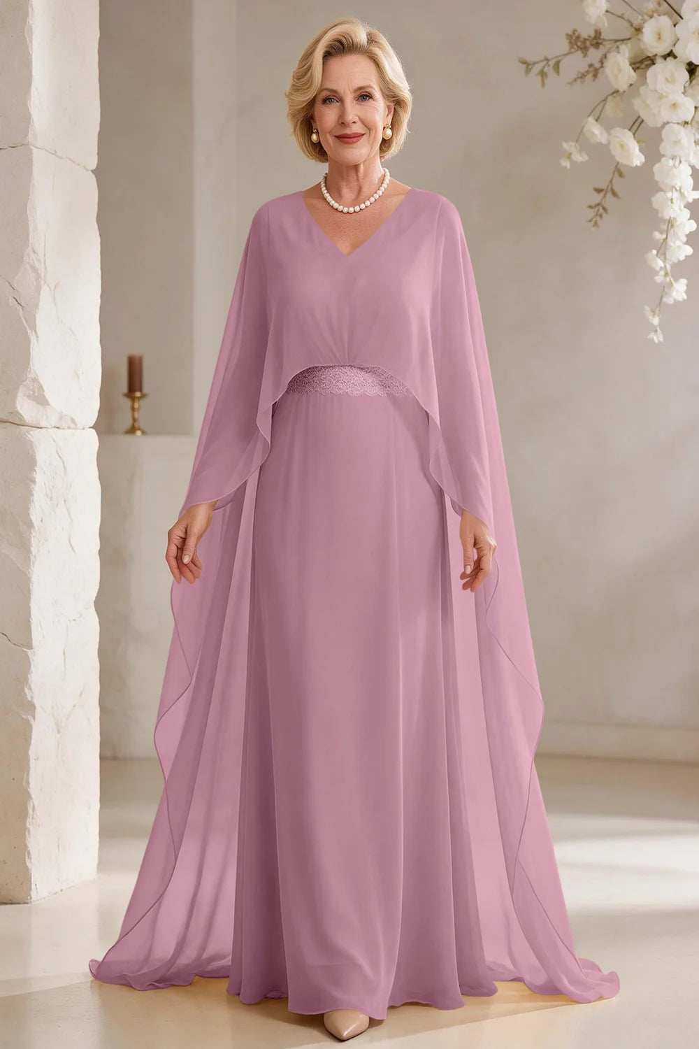 Front view of a pink dress with long cape panels and a flared skirt.