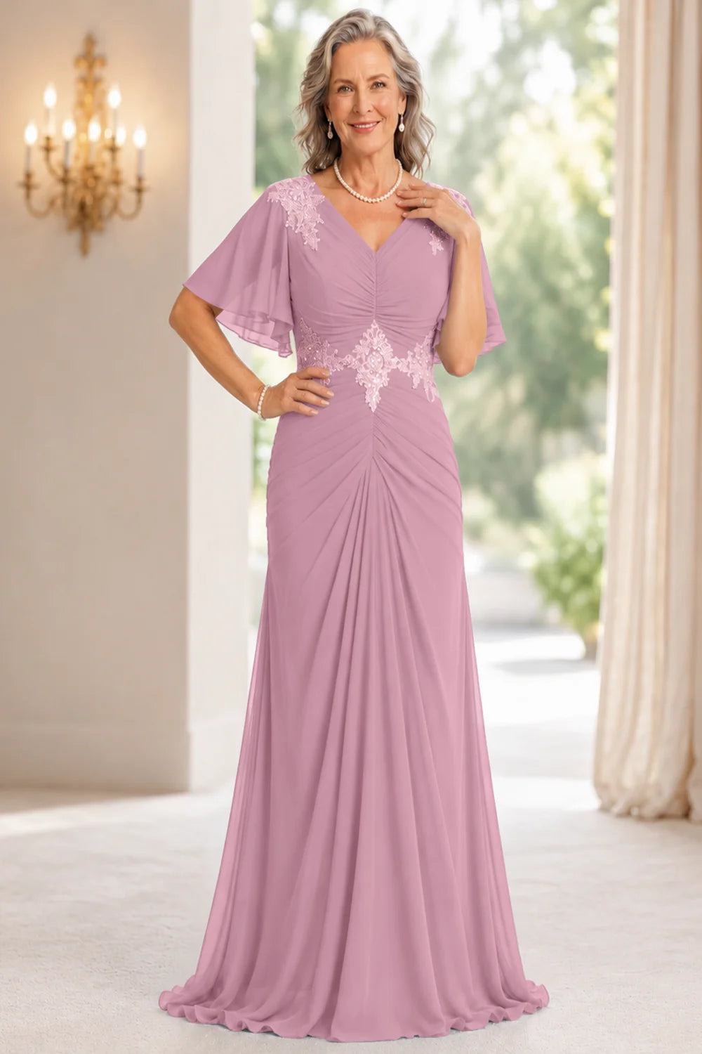 Front view of a pink dress with flutter sleeves and a ruched front.