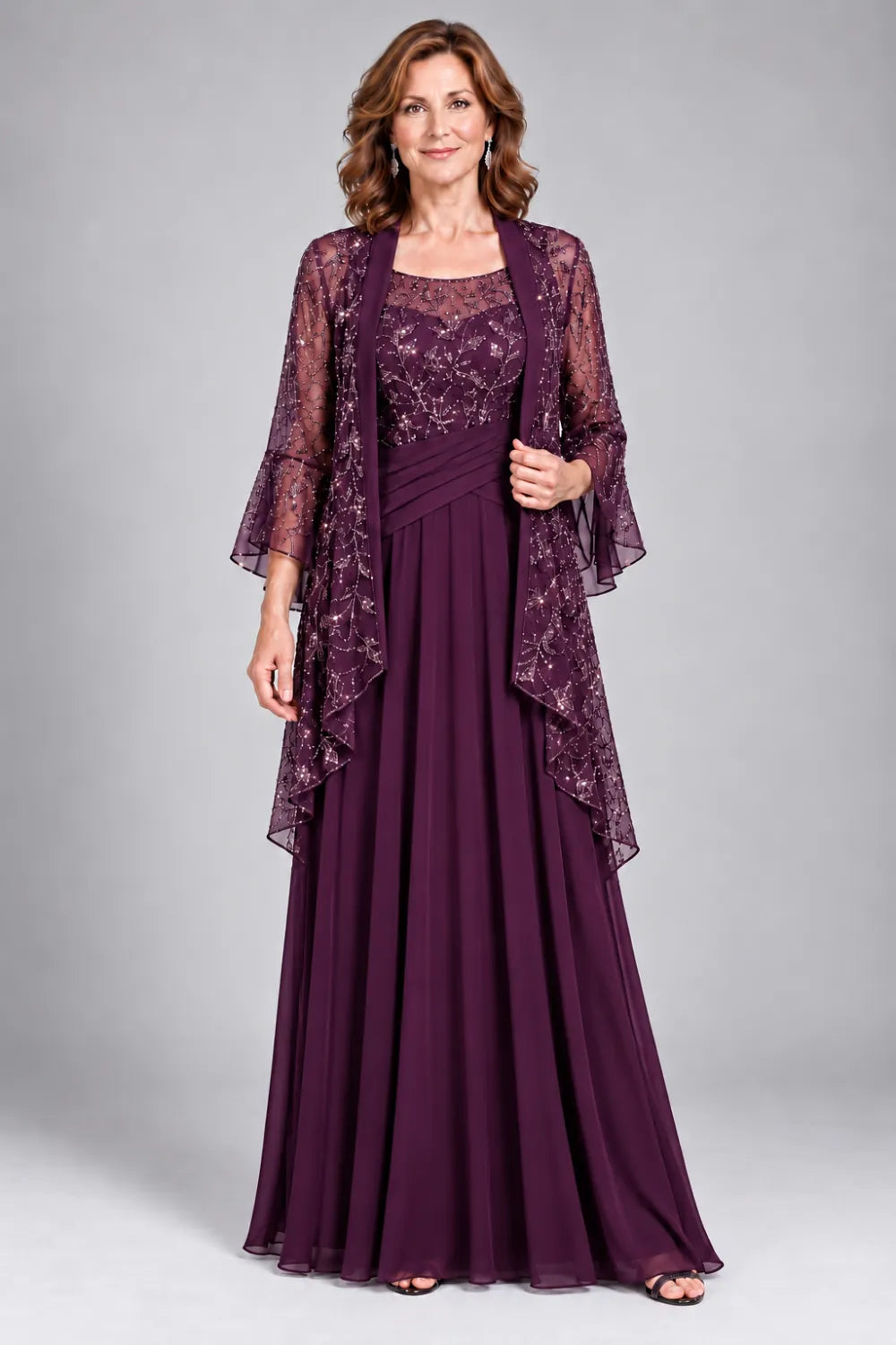 Plum dress with floral decorated bodice and diagonal gathered waist, front view.