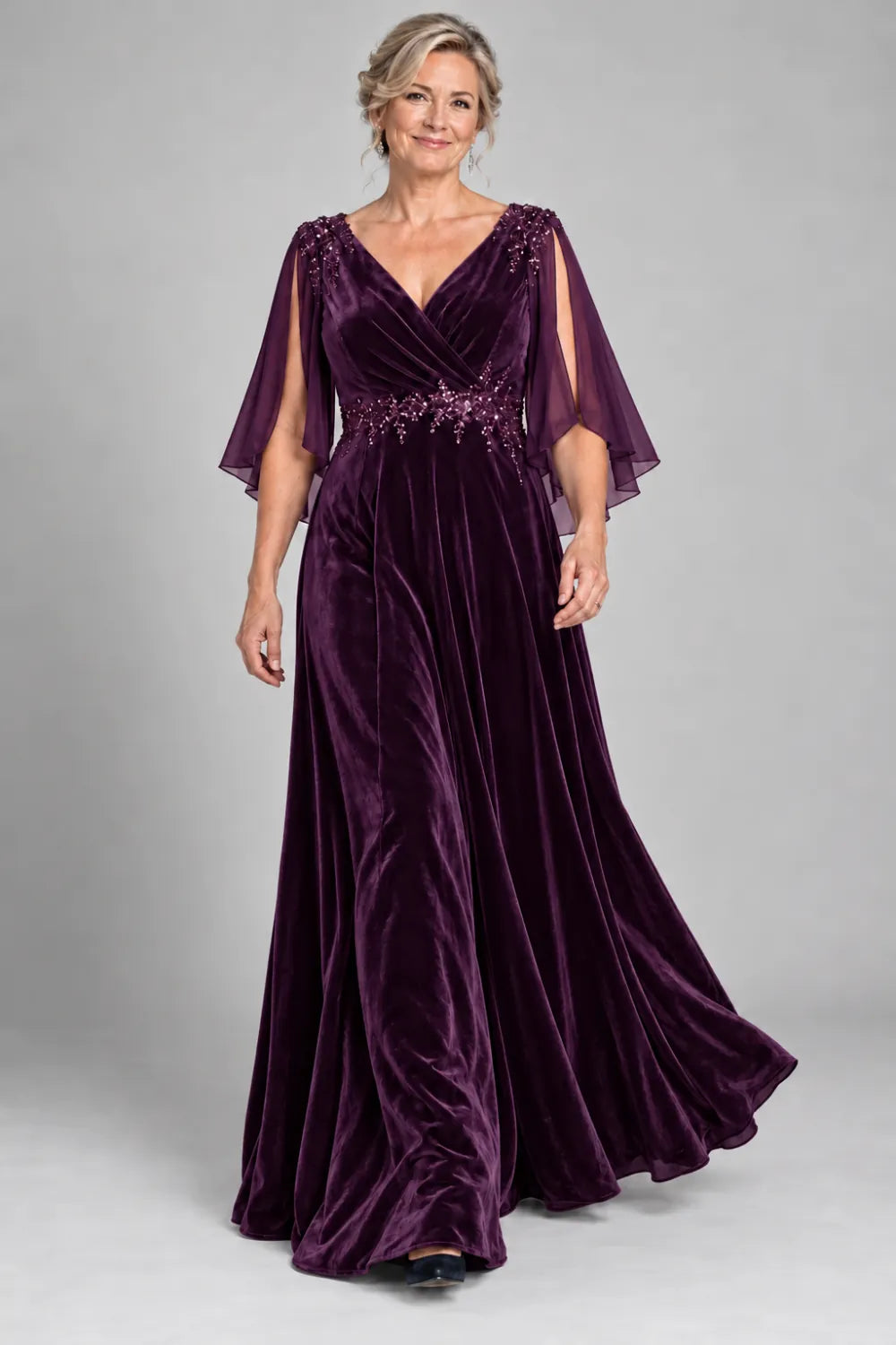 Plum dress with crossover bodice and decorated waist, front view.