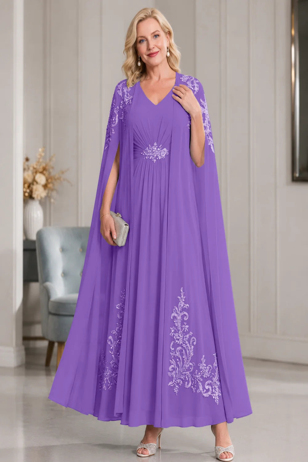 Front view of a purple dress with open cape panels and pale skirt motifs.
