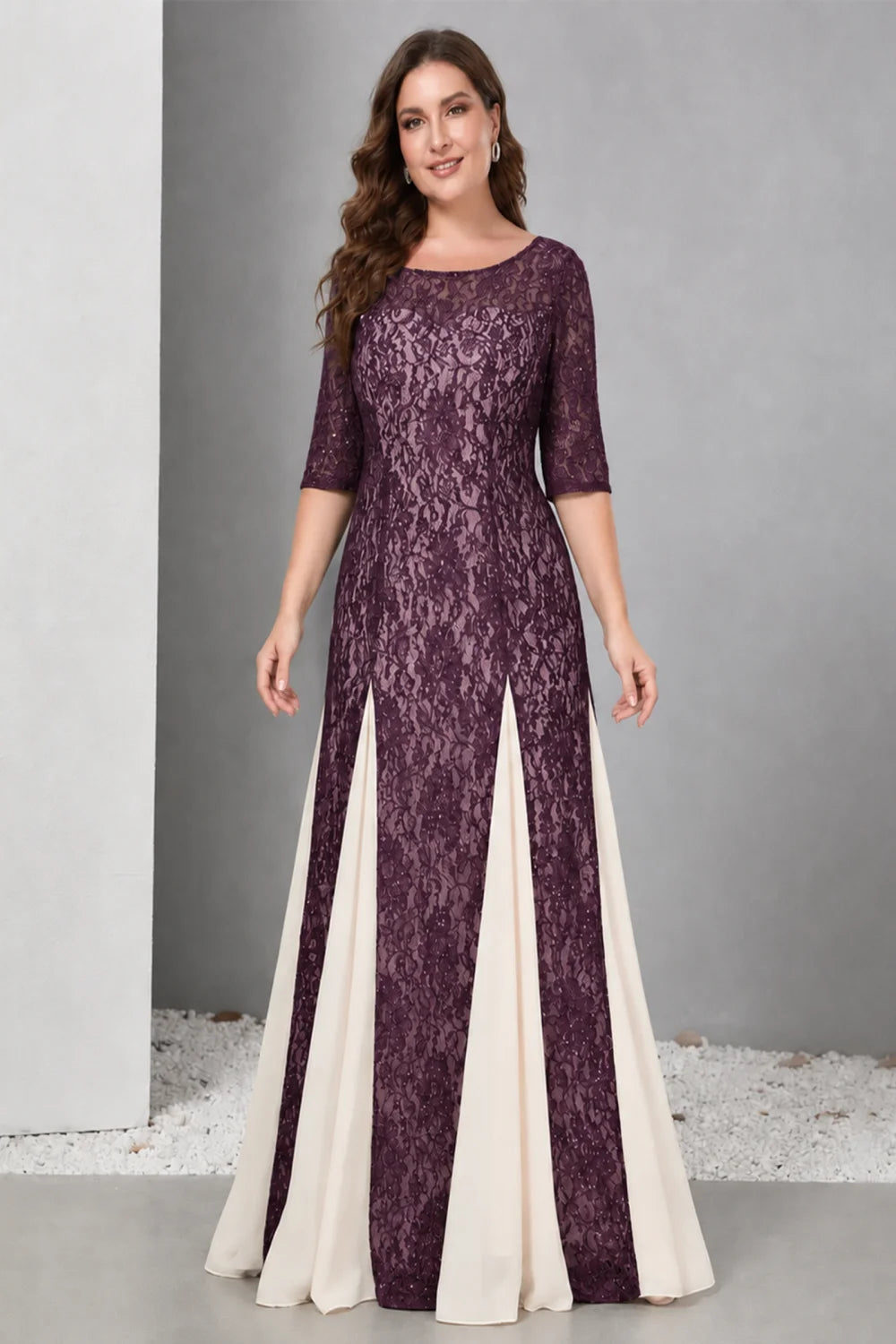 Front view of a purple dress with lace and contrasting pale skirt panels.