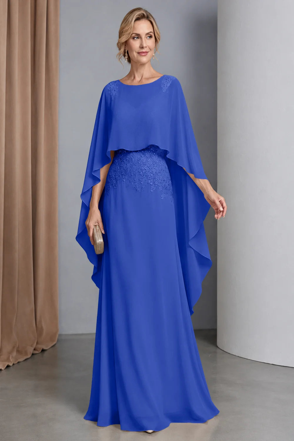 Front view of a royal blue dress with a curved cape front and embellished waist.