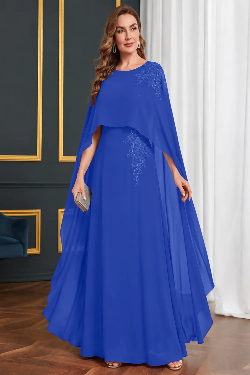 Front view of a royal blue dress with long cape panels and shoulder decoration.