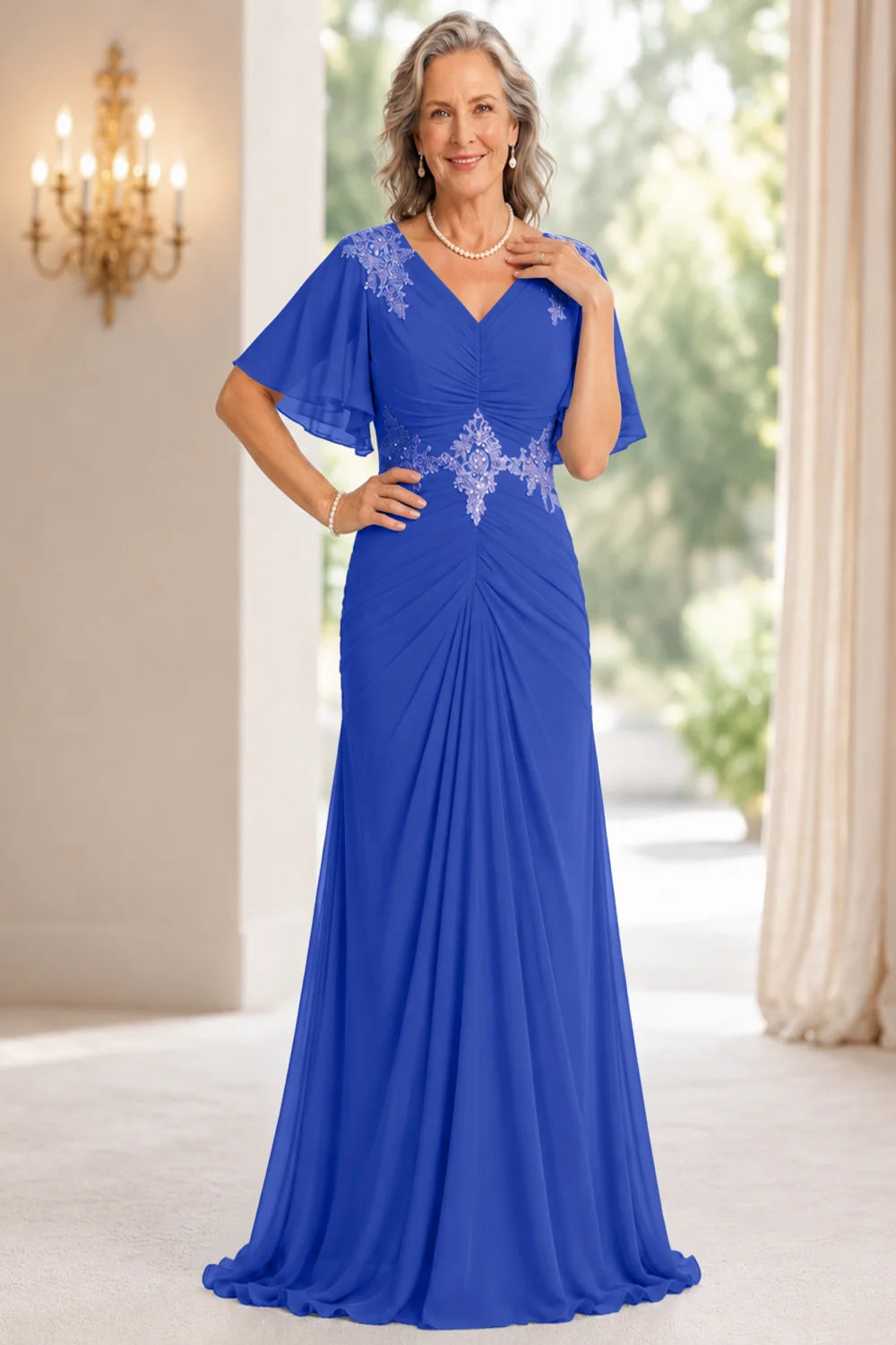 Front view of a royal blue dress with flutter sleeves and a ruched front.