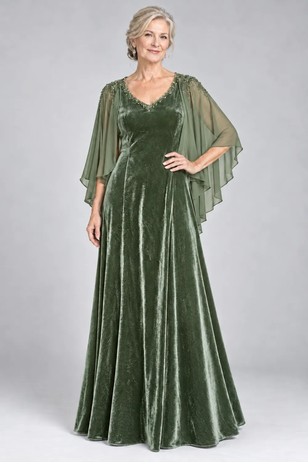 Sage Green dress with beaded v-neck and layered cascading cape, front view.