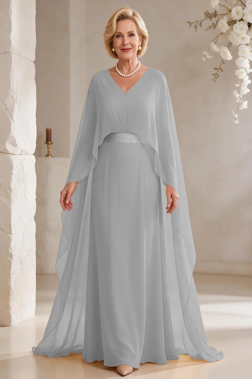 Front view of a silver gray dress with long cape panels and a flared skirt.
