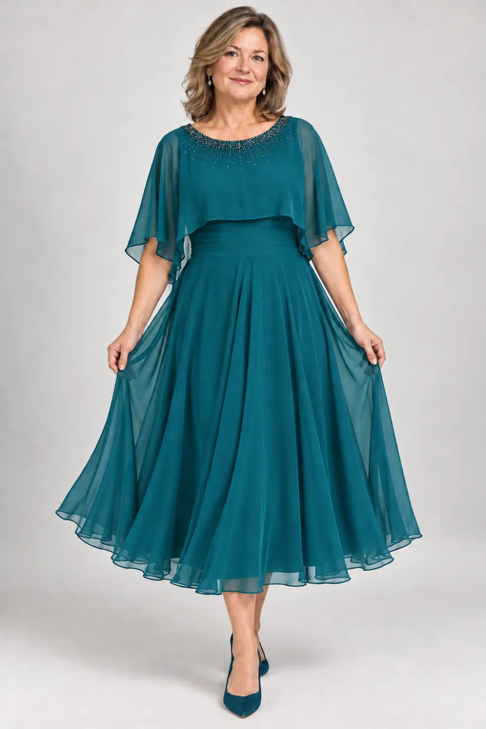Teal dress with narrow beaded neckline and defined waist, front view.