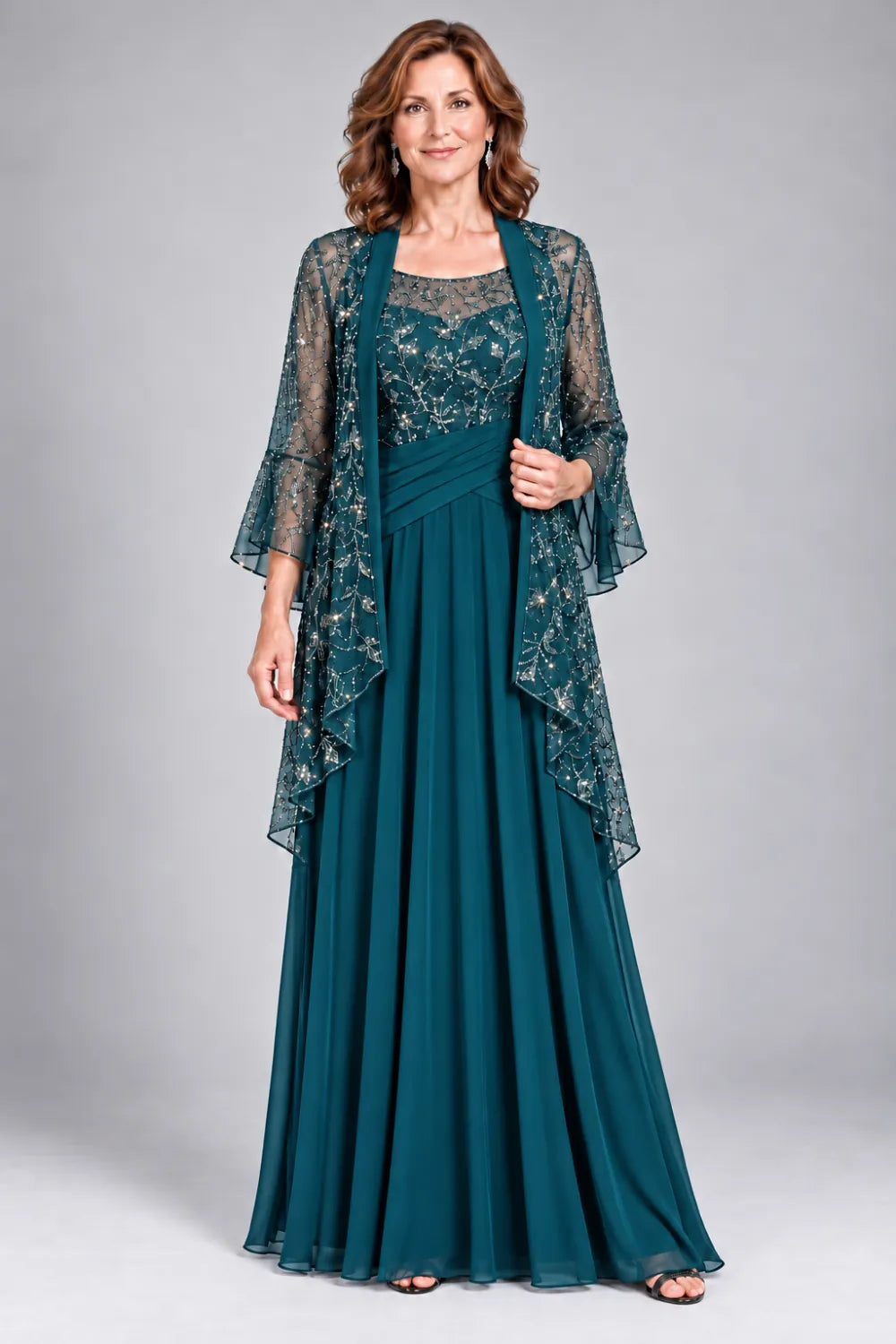 Teal dress with floral decorated bodice and diagonal gathered waist, front view.