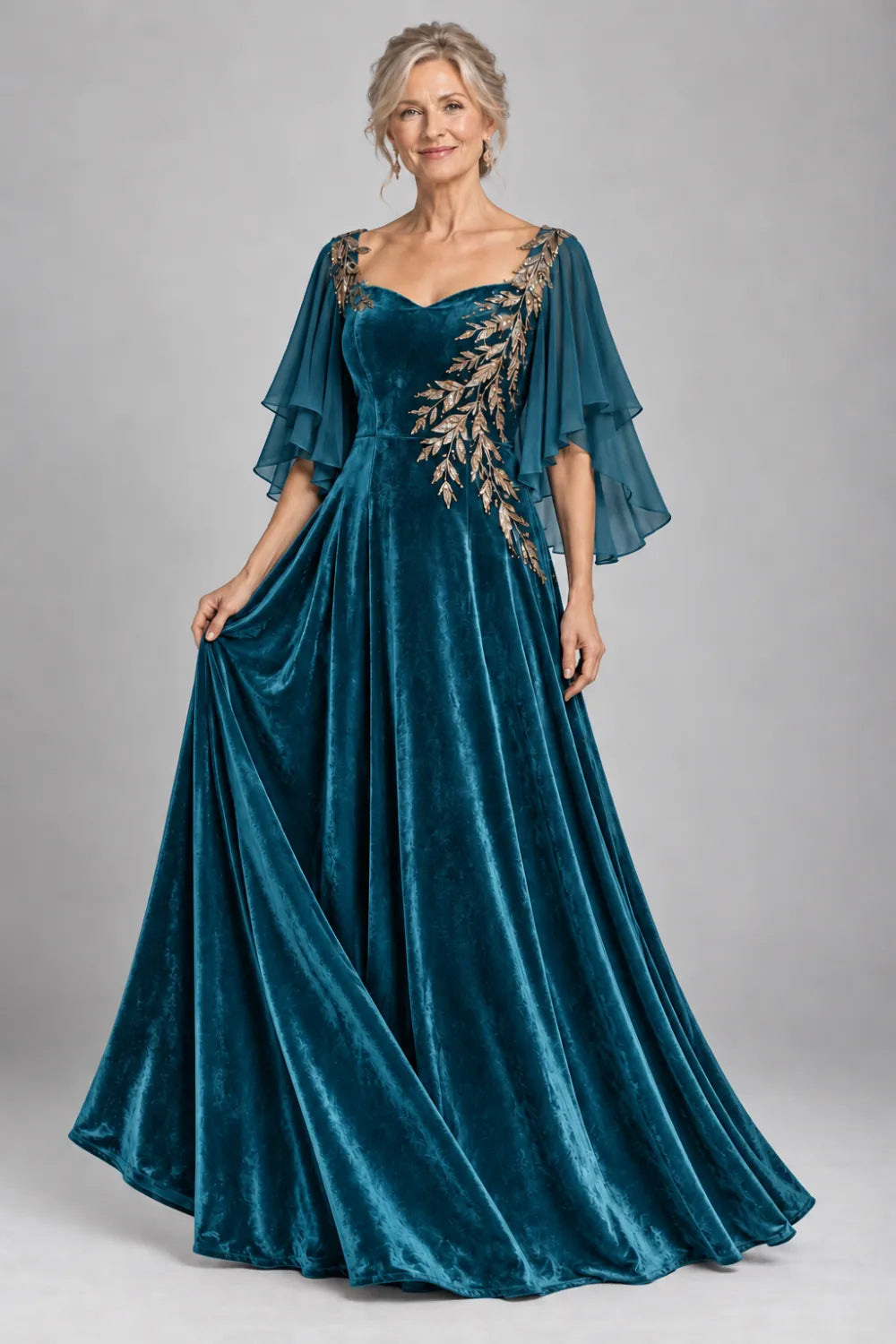 Teal dress with diagonal gold-tone leaf embroidery, front view.