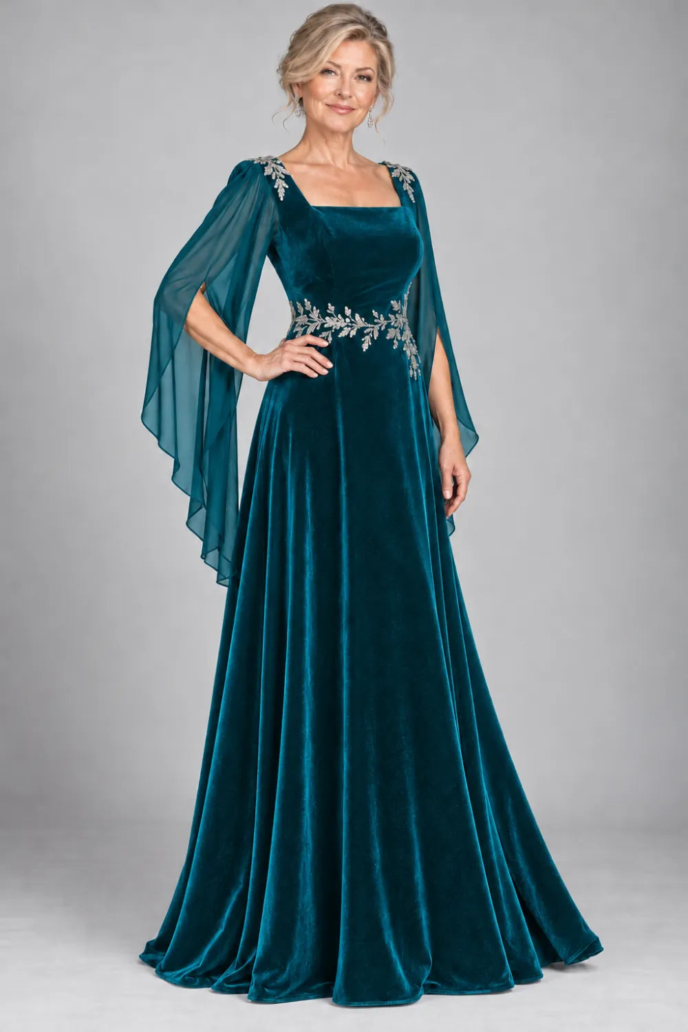 Teal dress with silver-tone leafy waist and shoulder accents, front view.