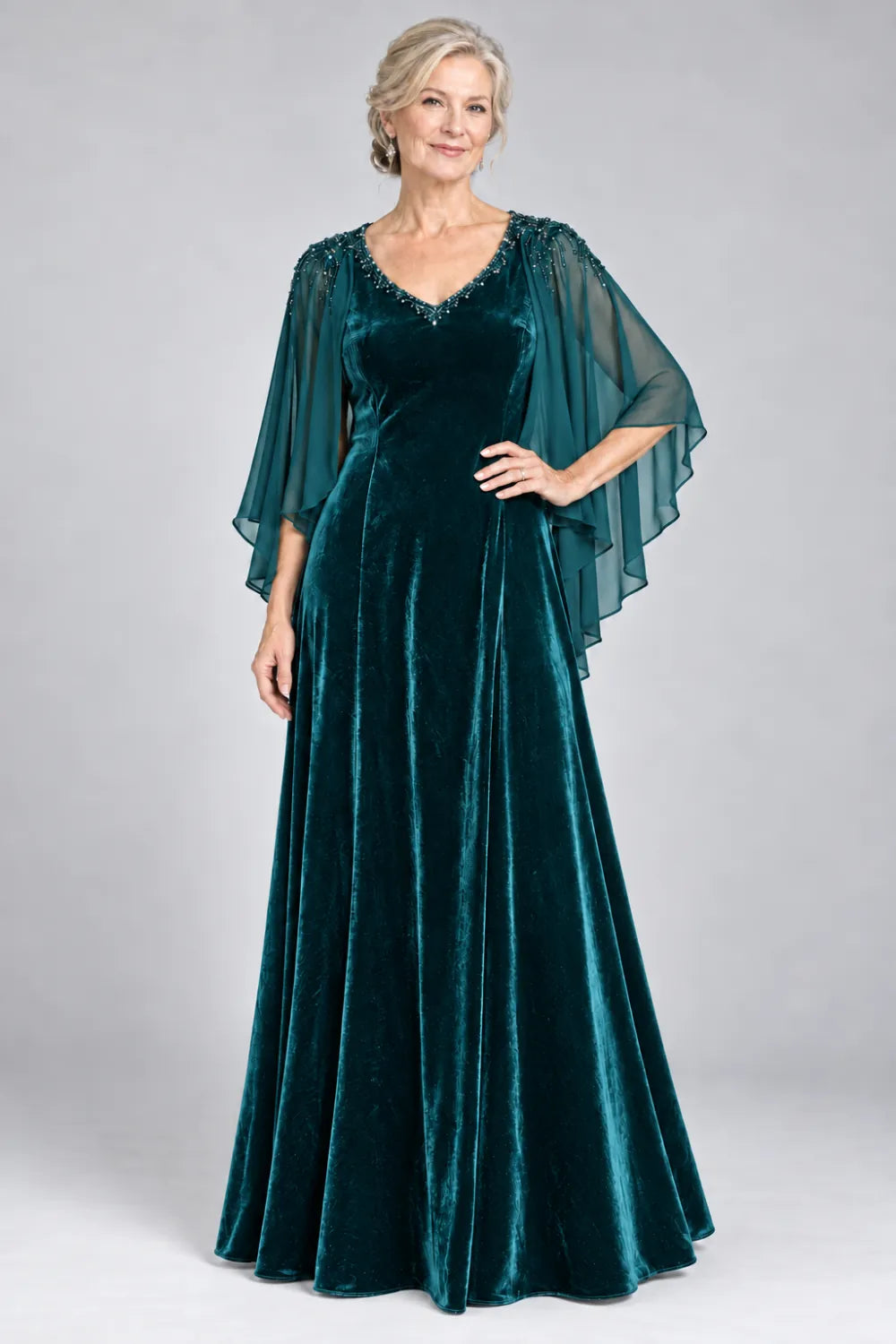 Teal dress with beaded v-neck and layered cascading cape, front view.