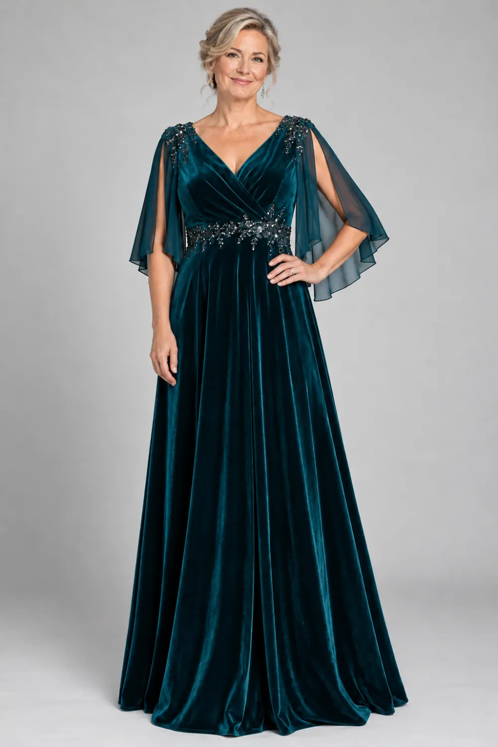 Teal dress with crossover bodice and decorated waist, posed front view.