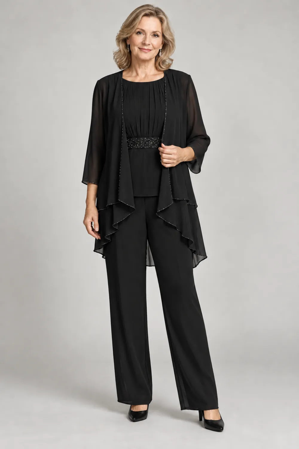 Black pant suit with gathered top and decorated horizontal waist band, front view.