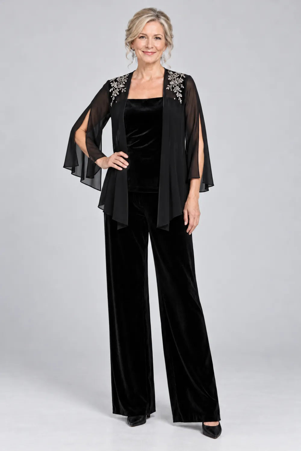 Black pant suit with floral shoulder embroidery and square-neck top, posed front view.