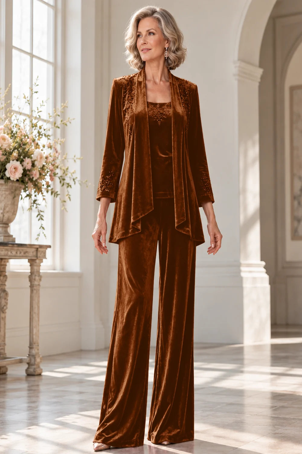 Front view of a brown pant suit with a waterfall jacket and matching trousers.