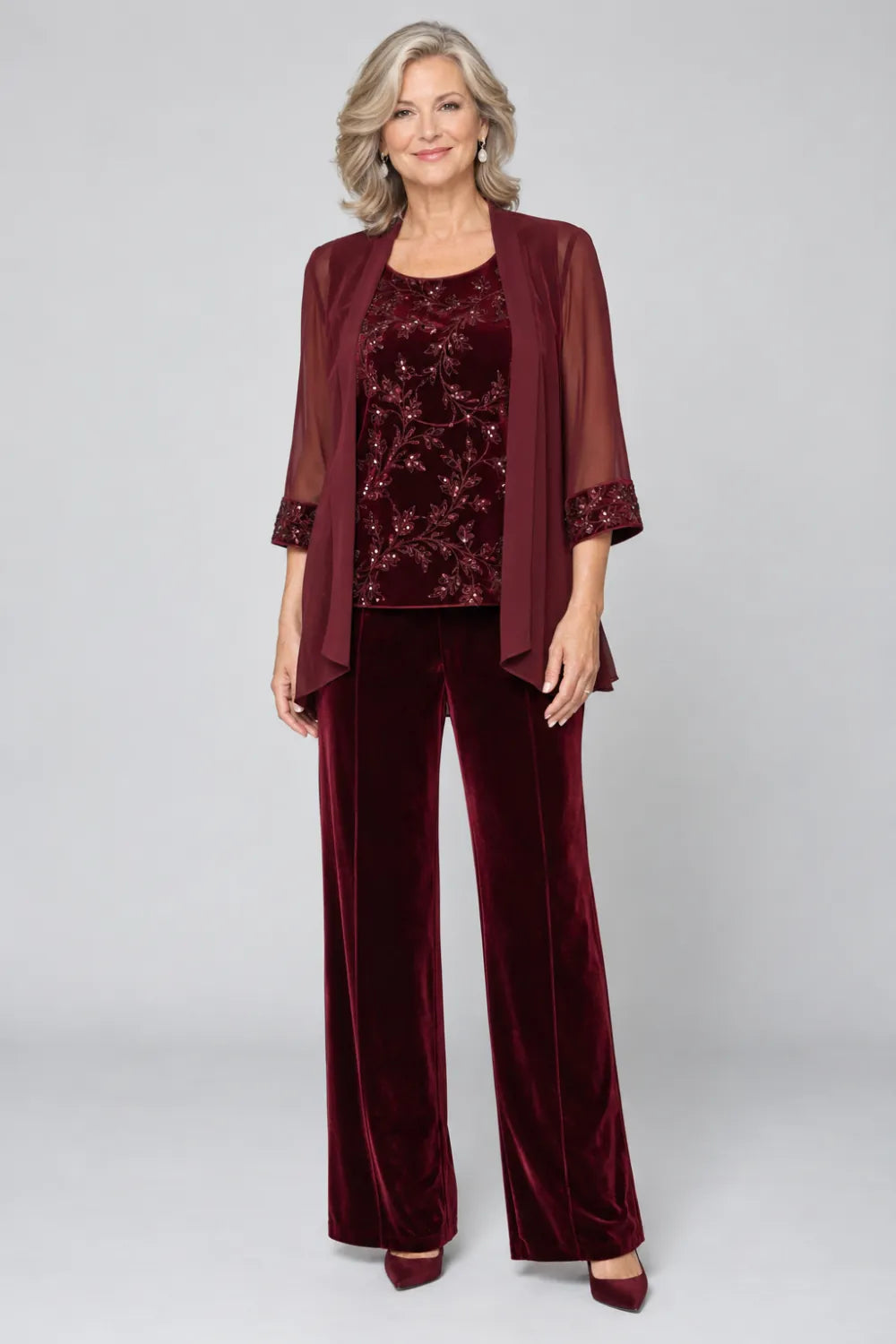Burgundy pant suit with tonal floral top and matching cuff panels, front view.