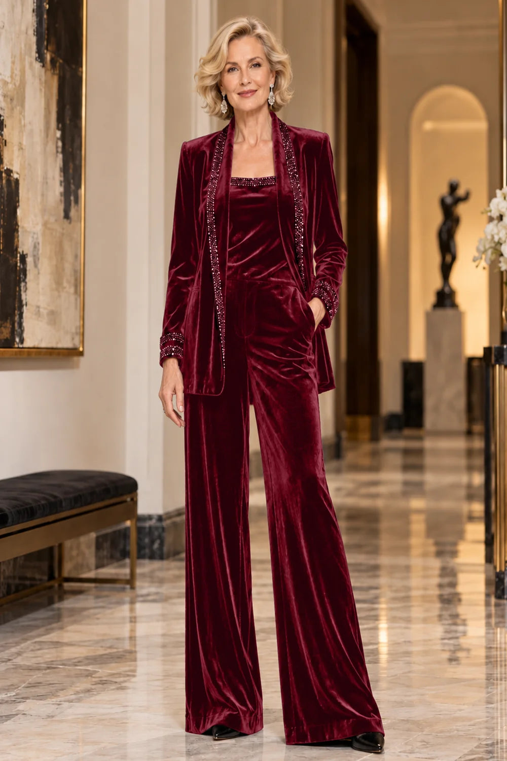 Front view of a burgundy pant suit with a trimmed jacket, matching top and wide-leg trousers.