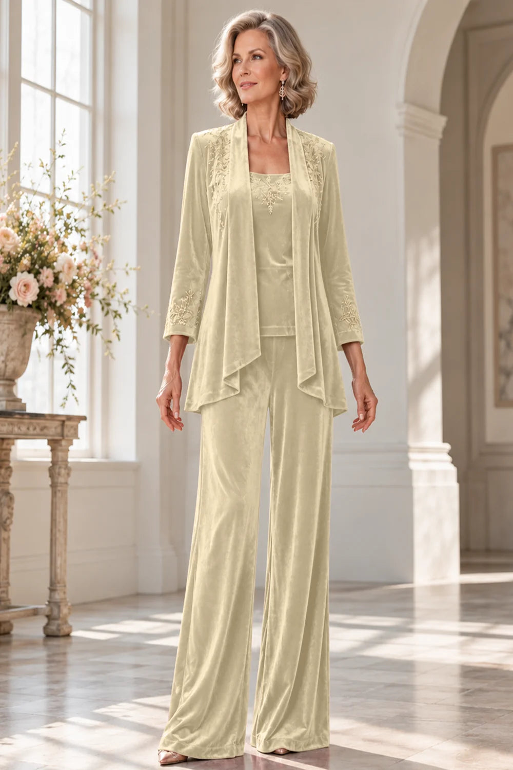 Front view of a champagne pant suit with a waterfall jacket and matching trousers.