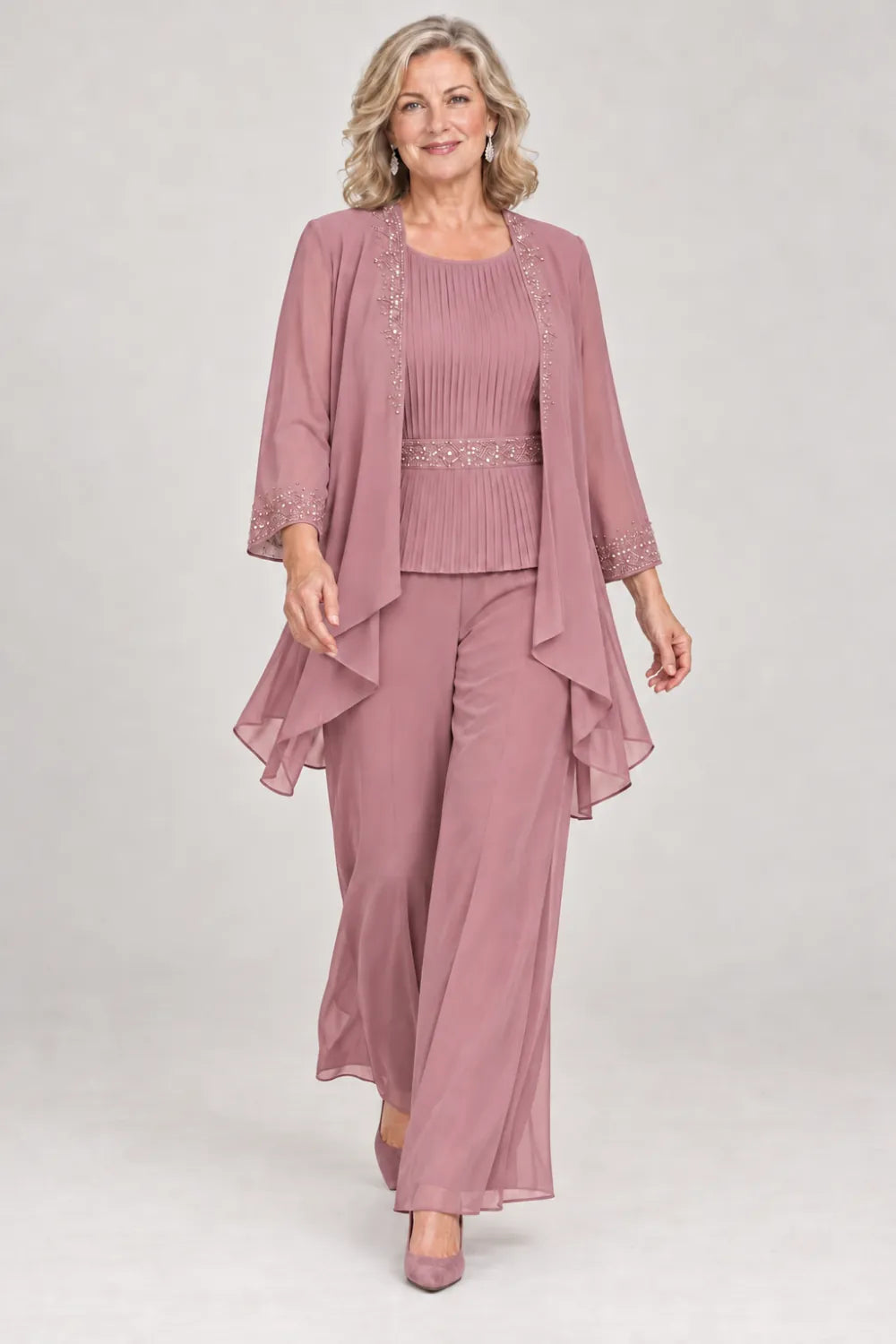 Dusty Rose pant suit with pleated top and beaded waist, jacket edges and cuffs, front view.