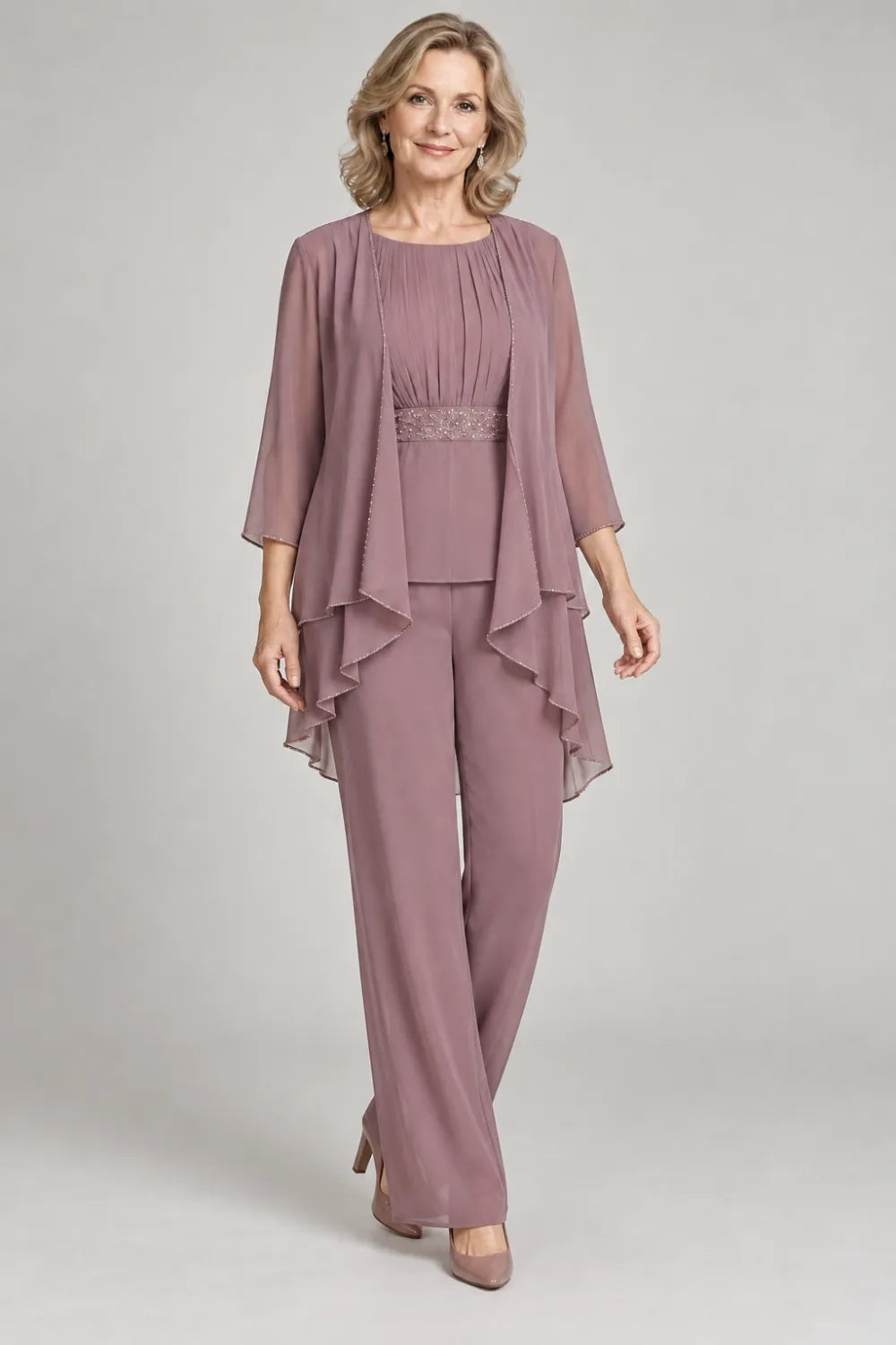 Mauve pant suit with gathered top and decorated horizontal waist band, posed front view.