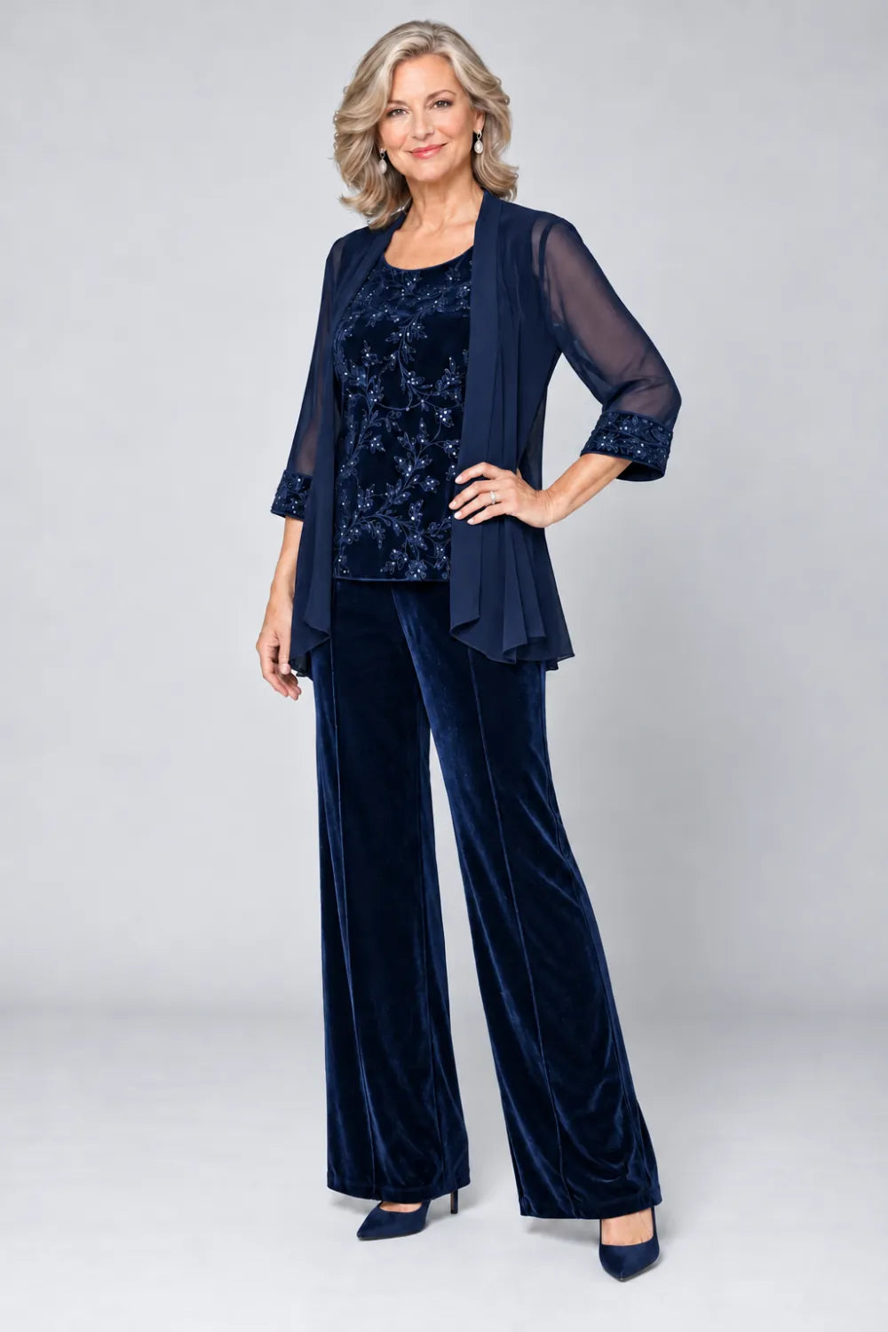 Navy Blue pant suit with tonal floral top and matching cuff panels, front view.