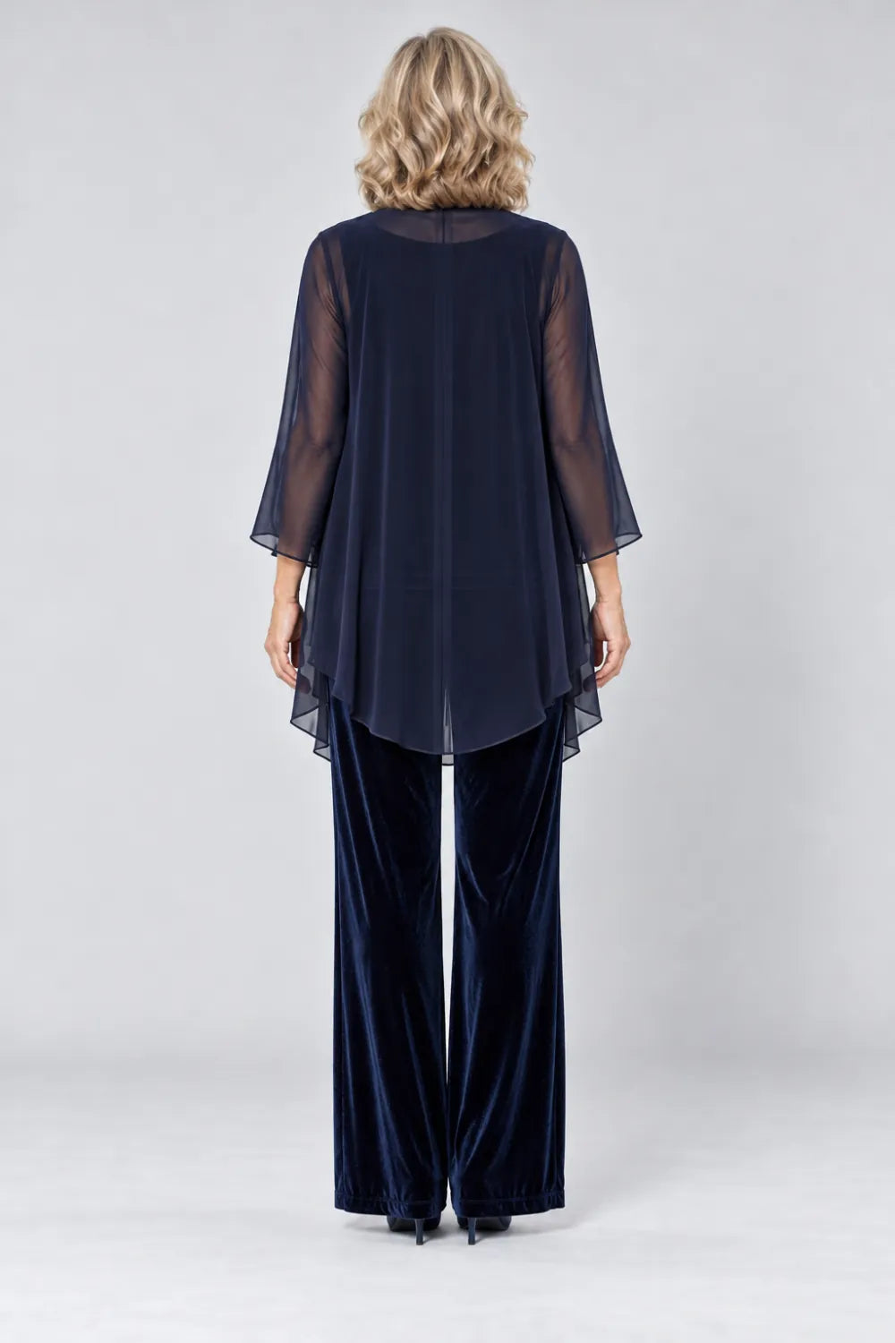 Back view of a navy blue wide-leg pant suit with sheer waterfall jacket with curved back hem.