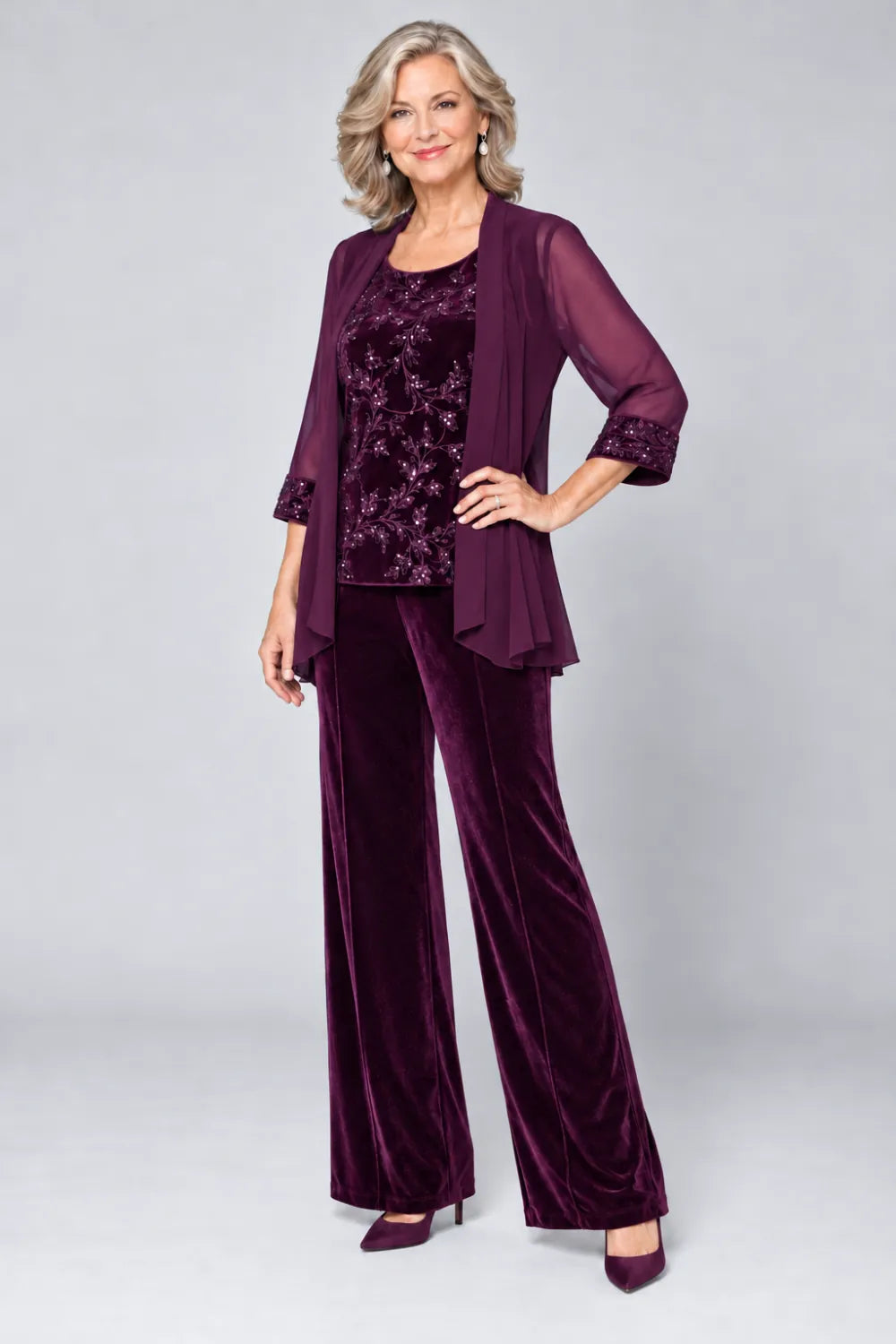 Plum pant suit with tonal floral top and matching cuff panels, front view.